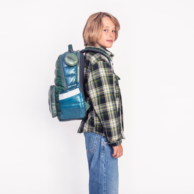 Boy wearing Jeune Premier New Bobbie Puffer Green school backpack, age 6 and up